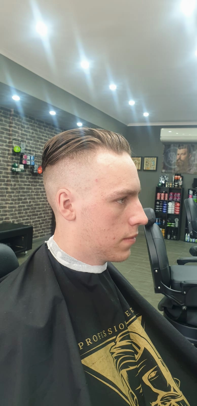 Young man with a slicked-back cut and a clean fade on the sides